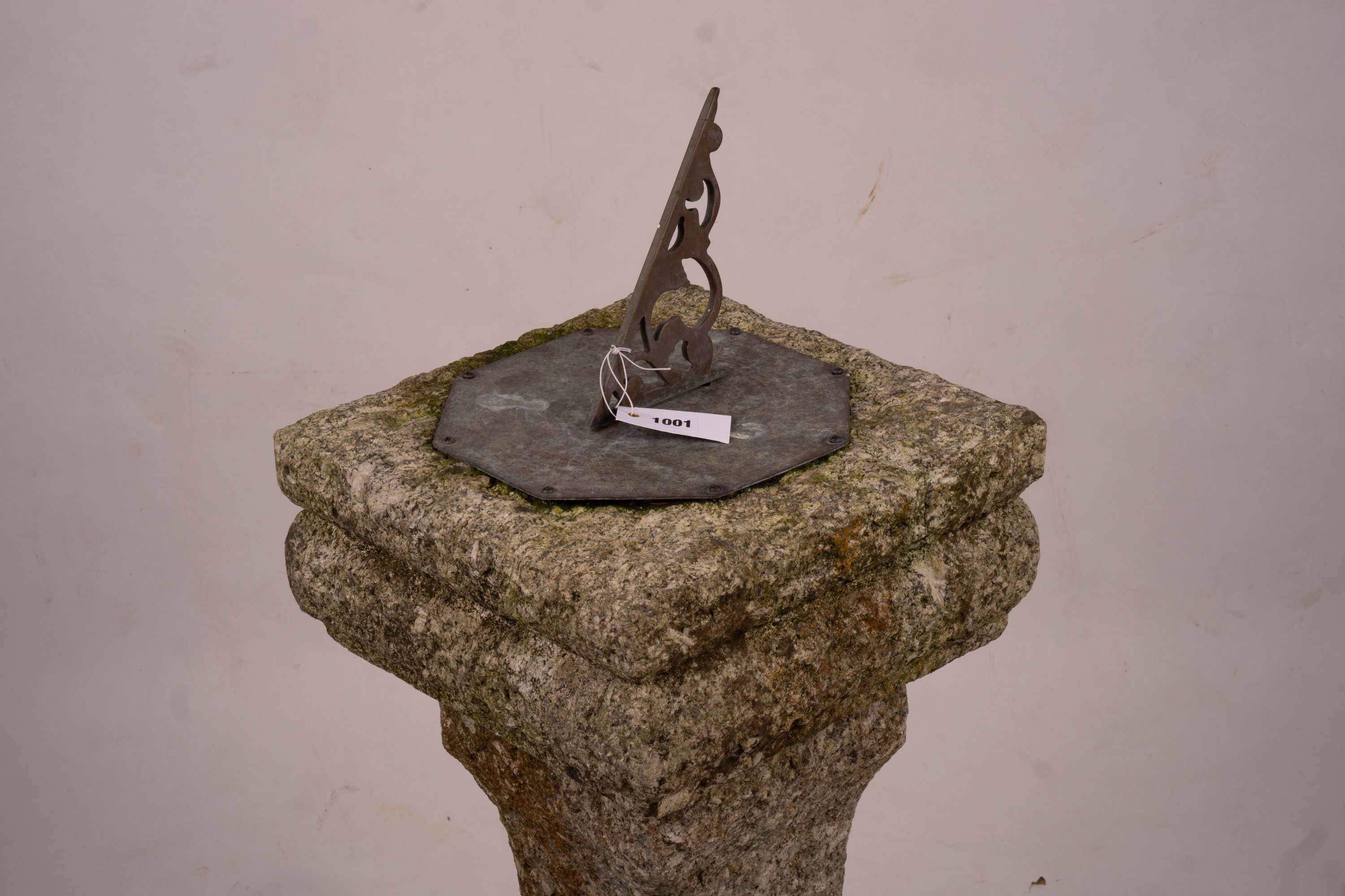 An octagonal sundial on reconstituted stone plinth, height 92cm
